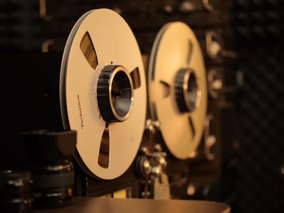 Two audio tape reels in warm golden light